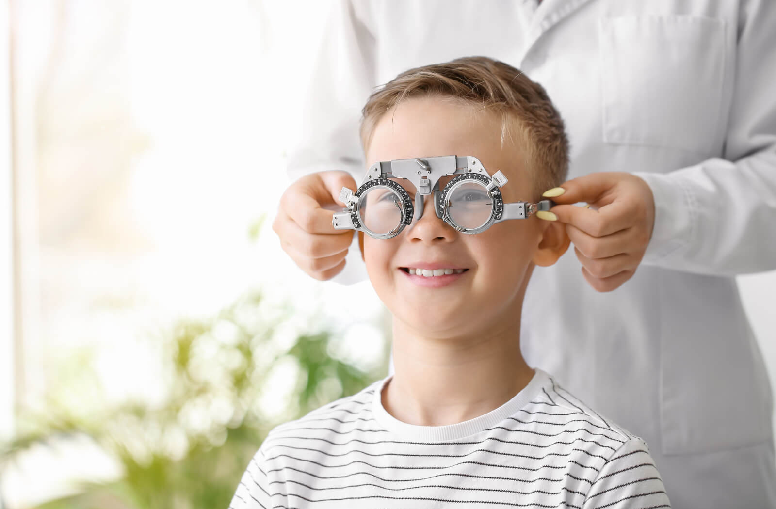 A young boy at the optical clinic is getting his eye test for his eyeglasses.